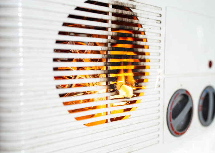 Electric fan heater exploding with sparks and flames